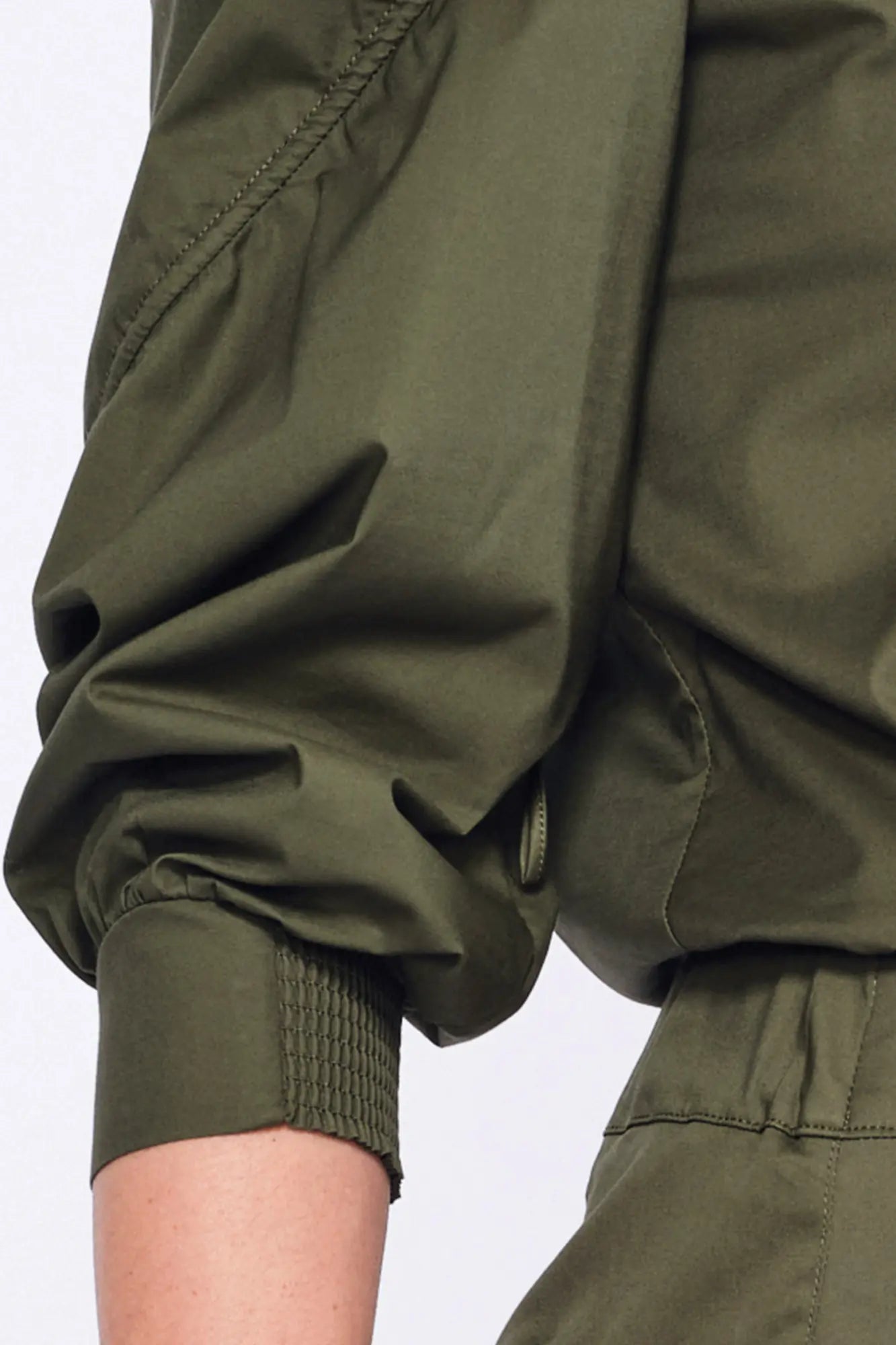 Close-up of the semi-elastic cuff and the gathered fabric of the puff sleeve on the Olive Bimba Blouse.
