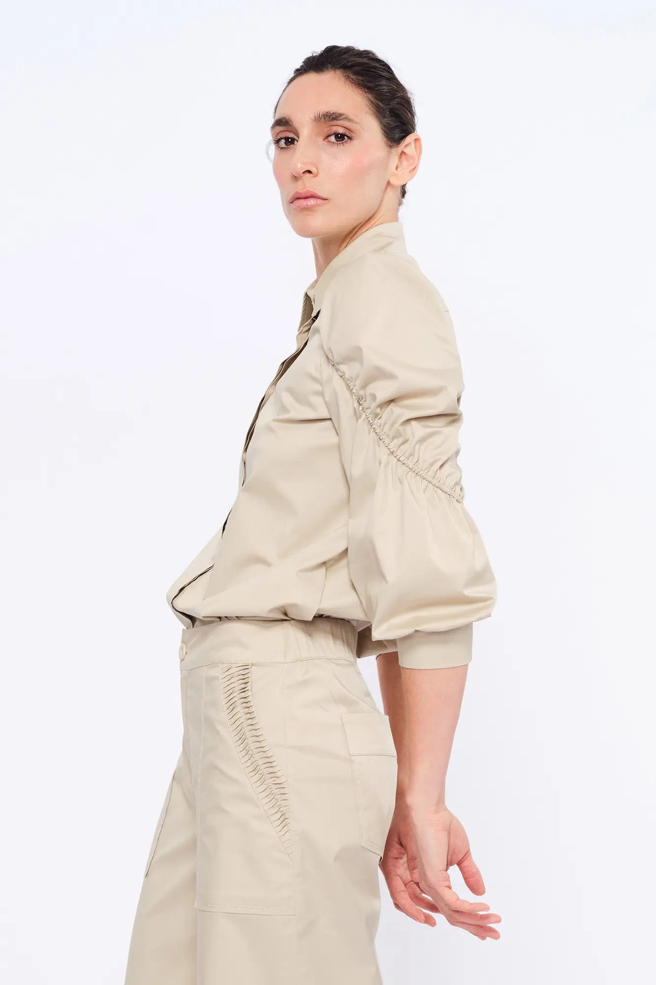 Side view of the Pristine Bimba Blouse, showcasing the sculptural volume of its puff sleeves.