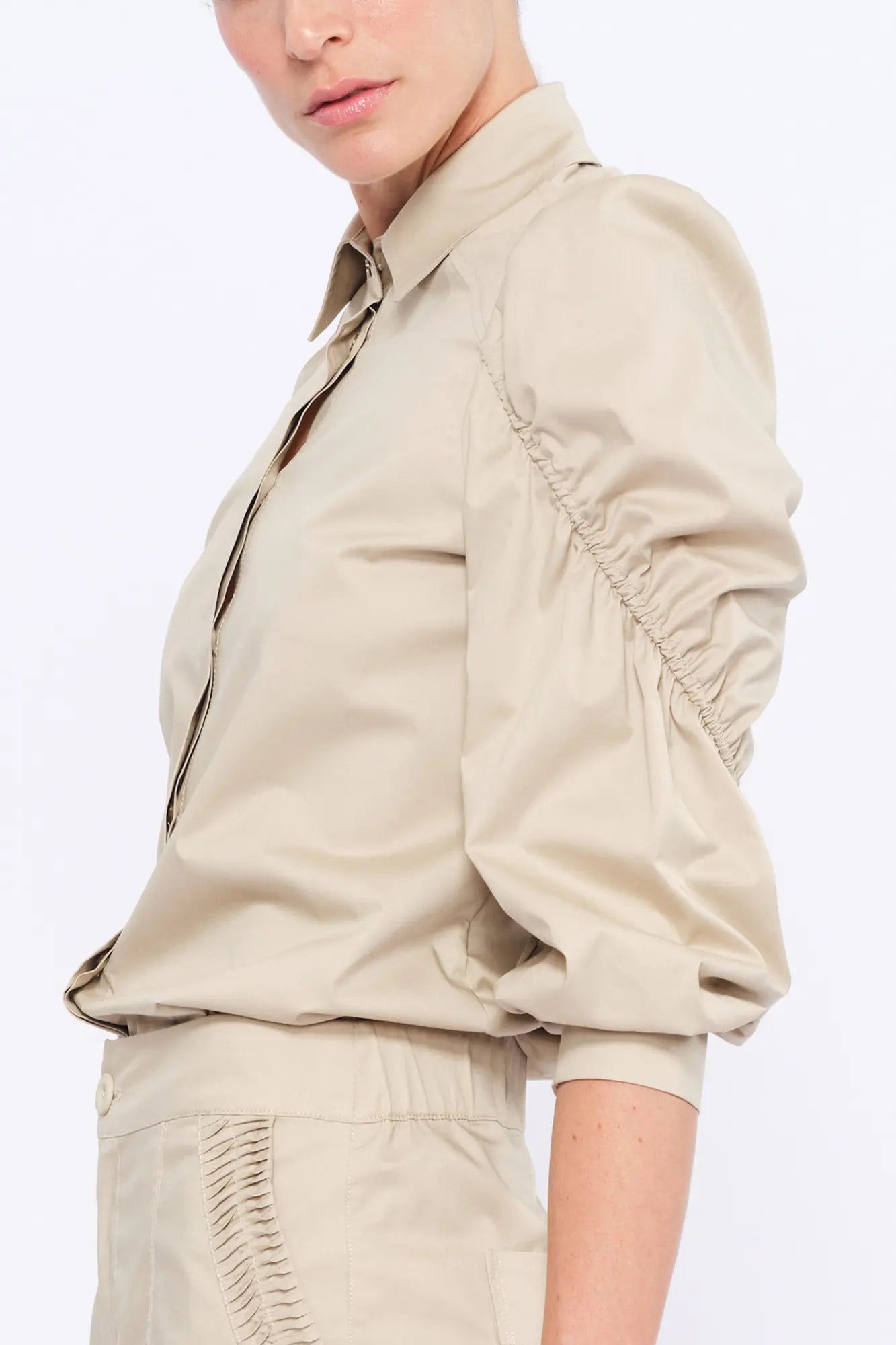 Side view of the Pristine Bimba Blouse, showcasing the sculptural volume of its puff sleeves.