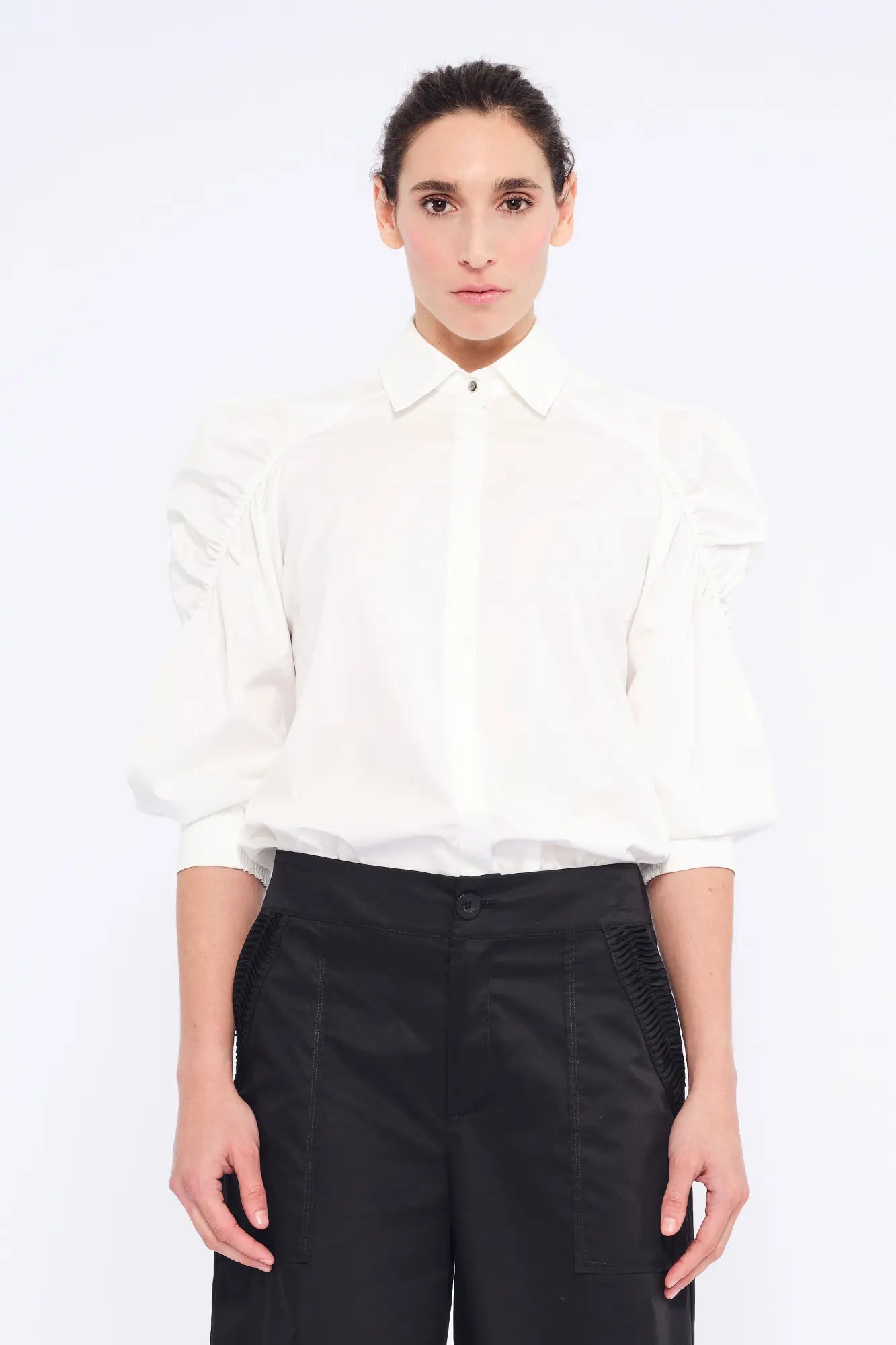 The Bimba Blouse in classic white, featuring its crisp shirt collar and relaxed fit.