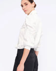Side view of the white Bimba Blouse, showcasing the soft, romantic volume of its puff sleeves.