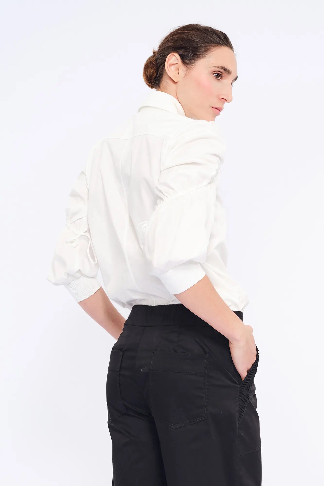Elegant back view of the classic white Bimba Blouse.