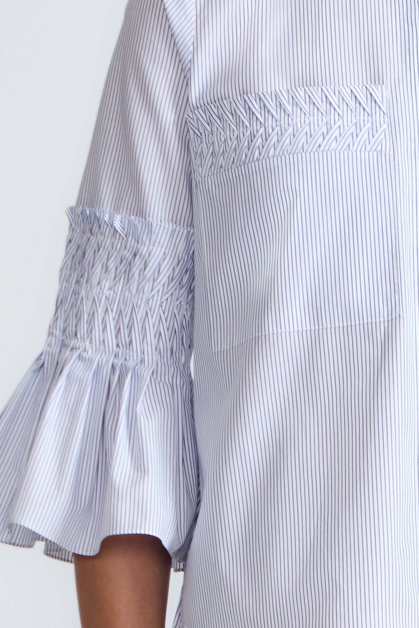 Callie Blouse – 100% cotton shirt blouse with hidden buttons, ¾ sleeves, and smocked cuffs and pockets. Made in Peru.