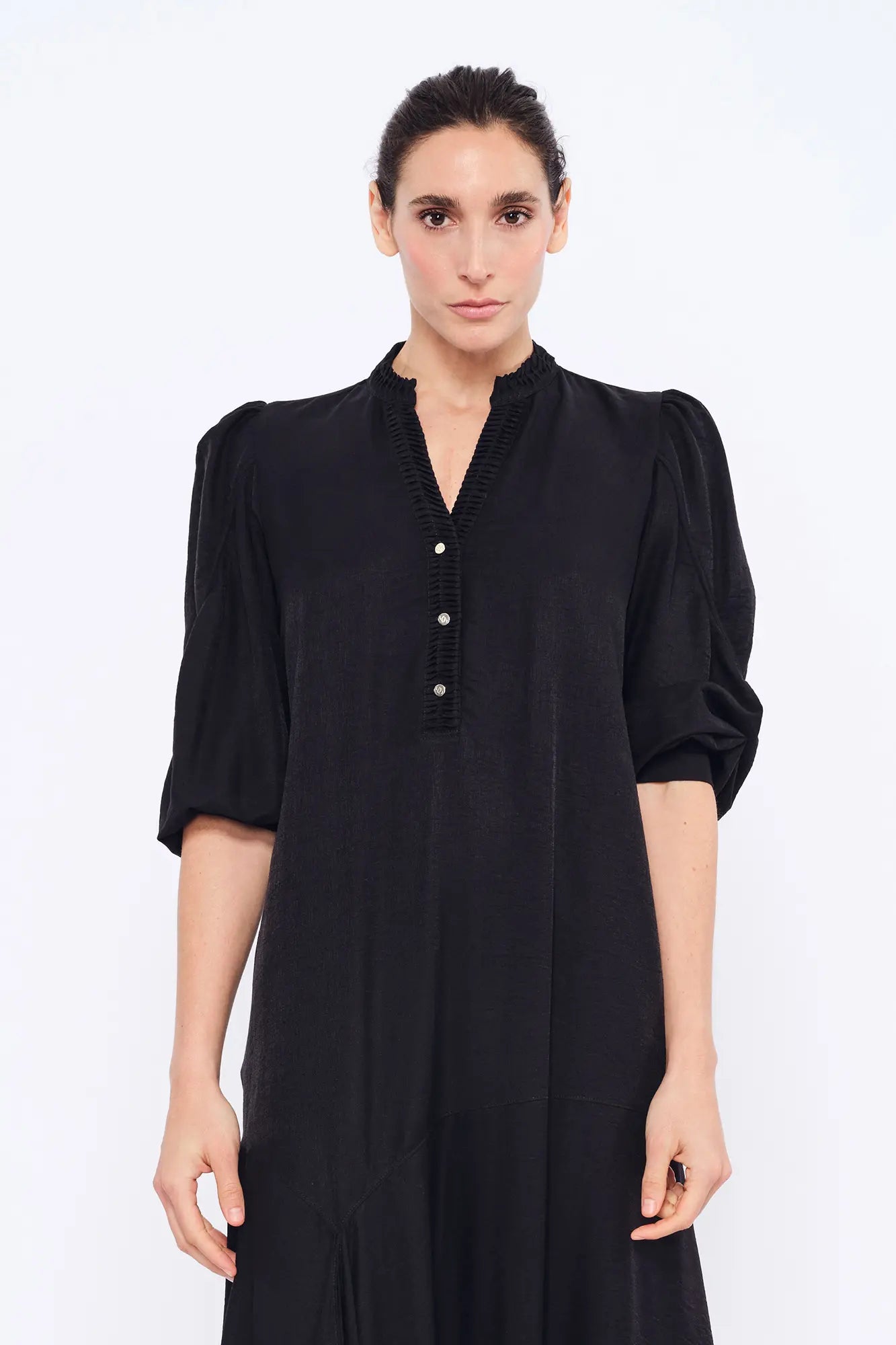 Front view of the Carlie Dress in essential black, showcasing its powerful, elegant silhouette.