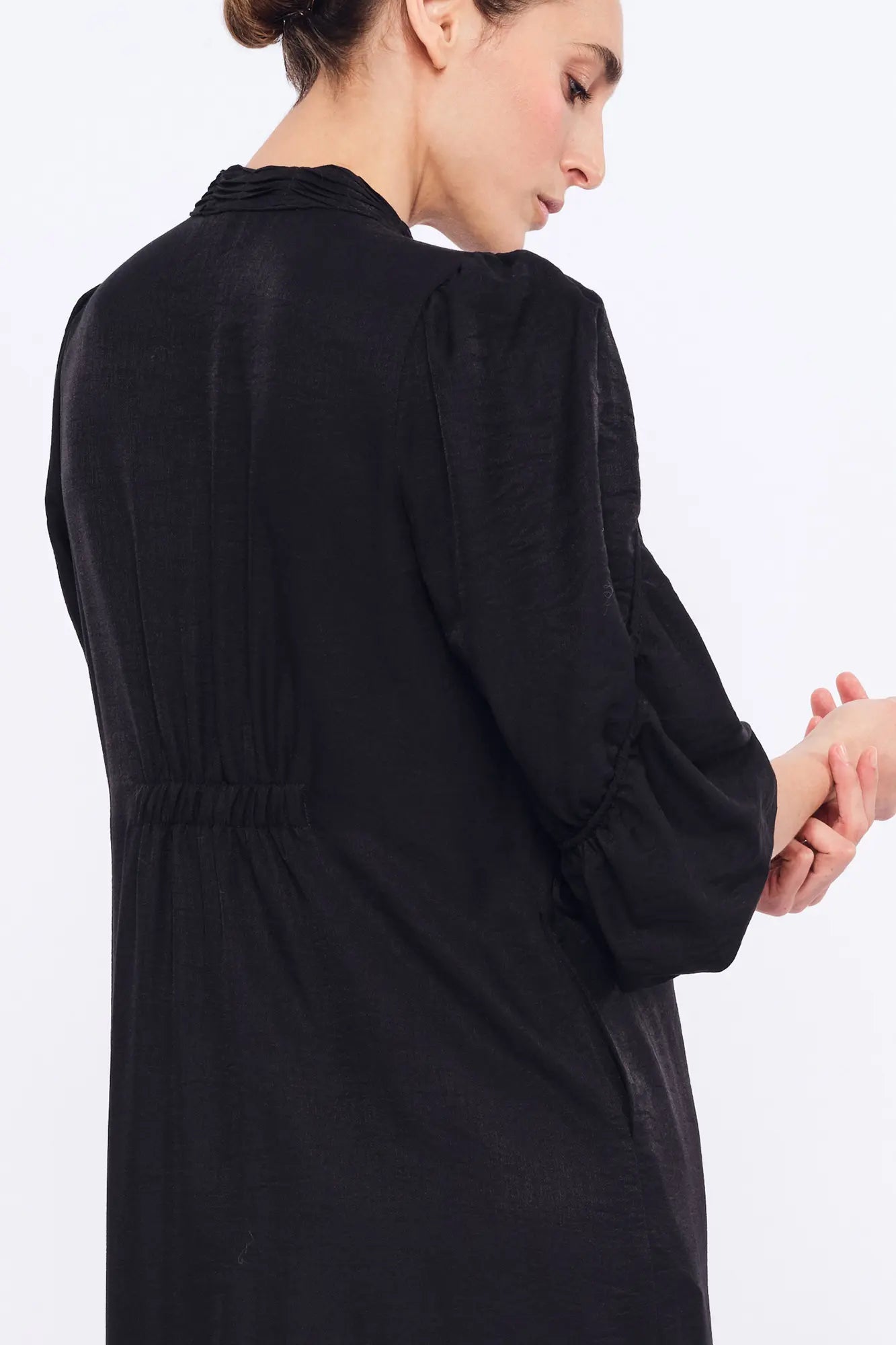 Clean back silhouette of the Carlie Dress, crafted from a fluid woven fabric.