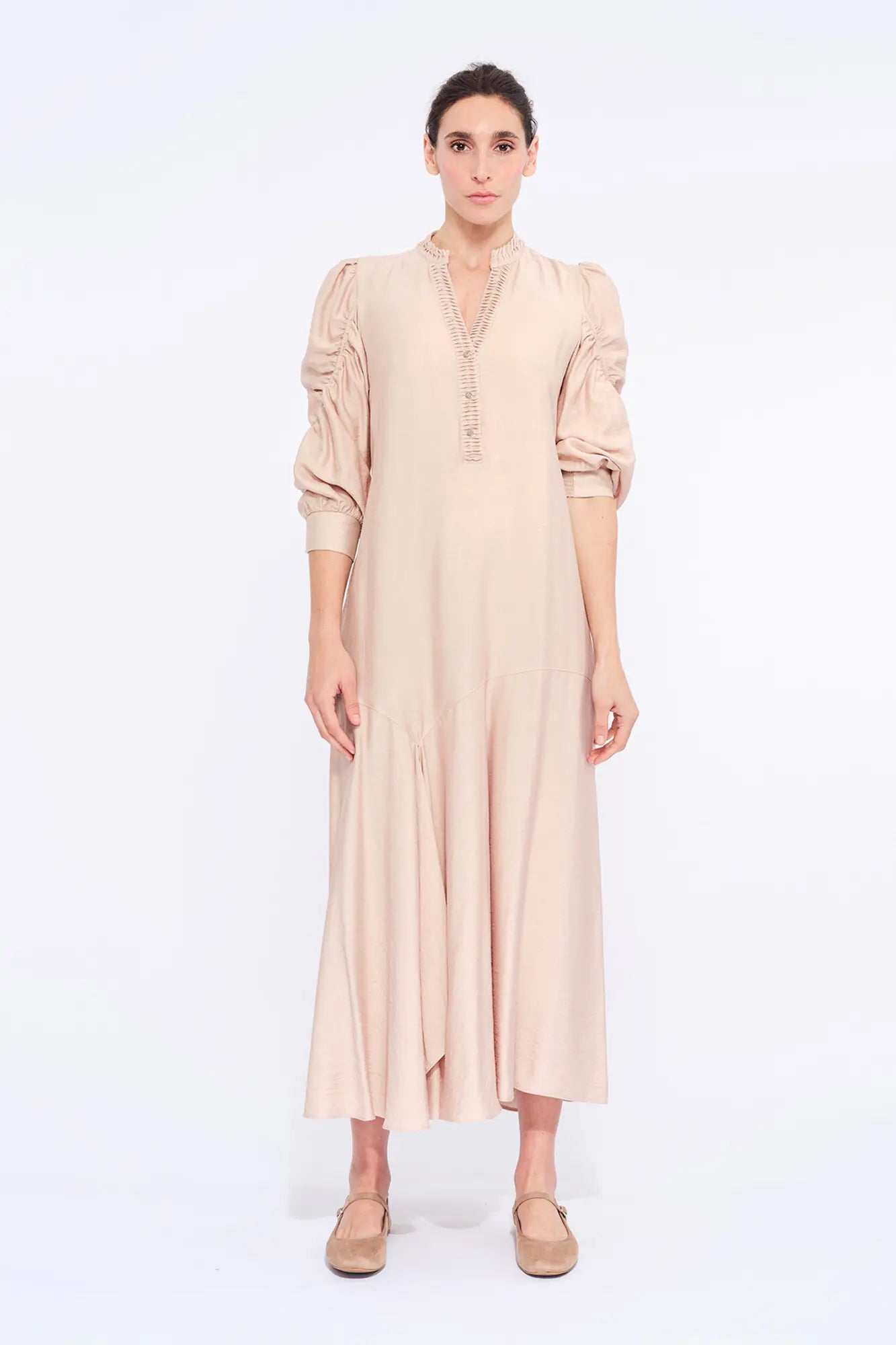 Front view of the Carlie Dress in Nude, showcasing its gathered V-neckline and asymmetrical skirt.