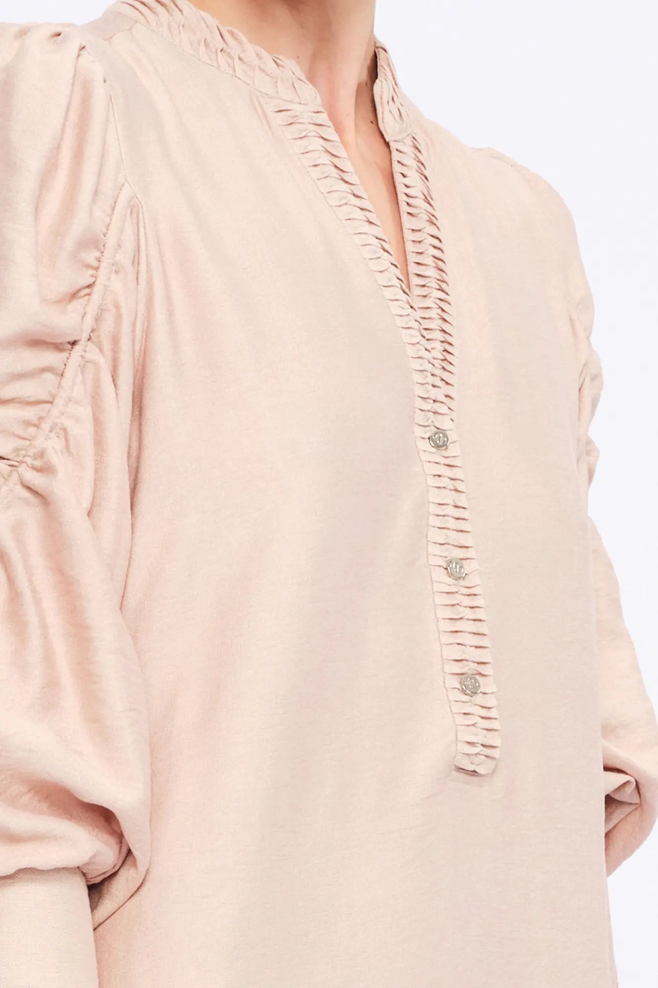 Close-up of the gathered neckline and the proprietary woven fabric of the Nude Carlie Dress.