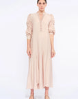 Front view of the Carlie Dress in Nude, showcasing its gathered V-neckline and asymmetrical skirt.