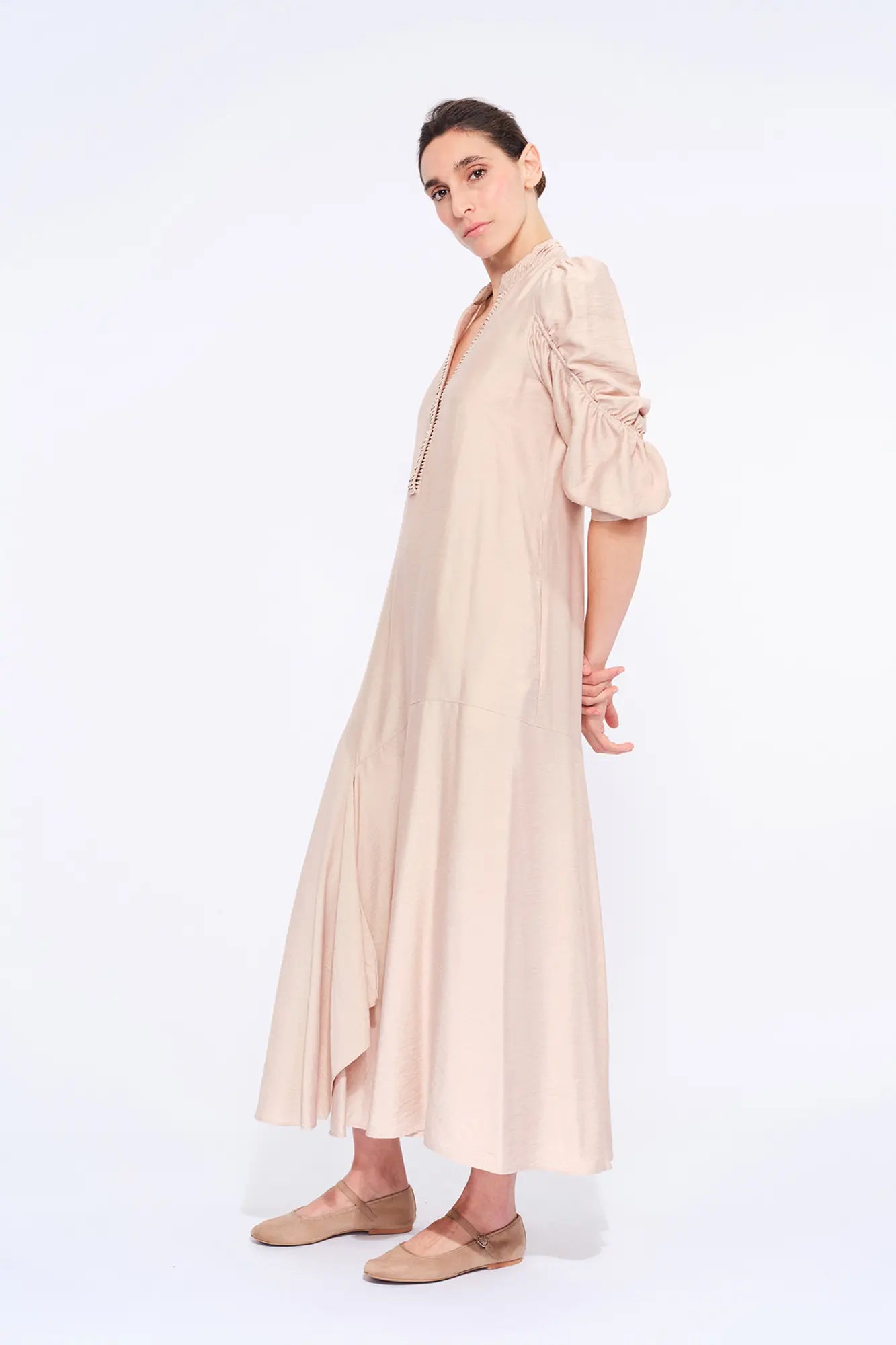 Side profile of the Nude Carlie Dress, highlighting the dramatic volume of the puff sleeves.