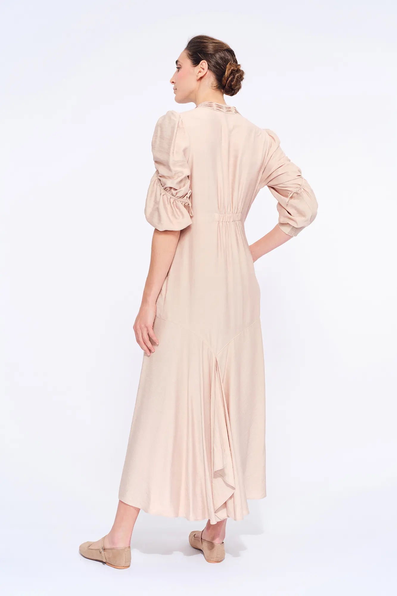 Elegant back silhouette of the Carlie Dress, showing the fluid drape of the fabric.