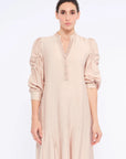 Front view of the Carlie Dress in Nude, showcasing its gathered V-neckline and asymmetrical skirt.

