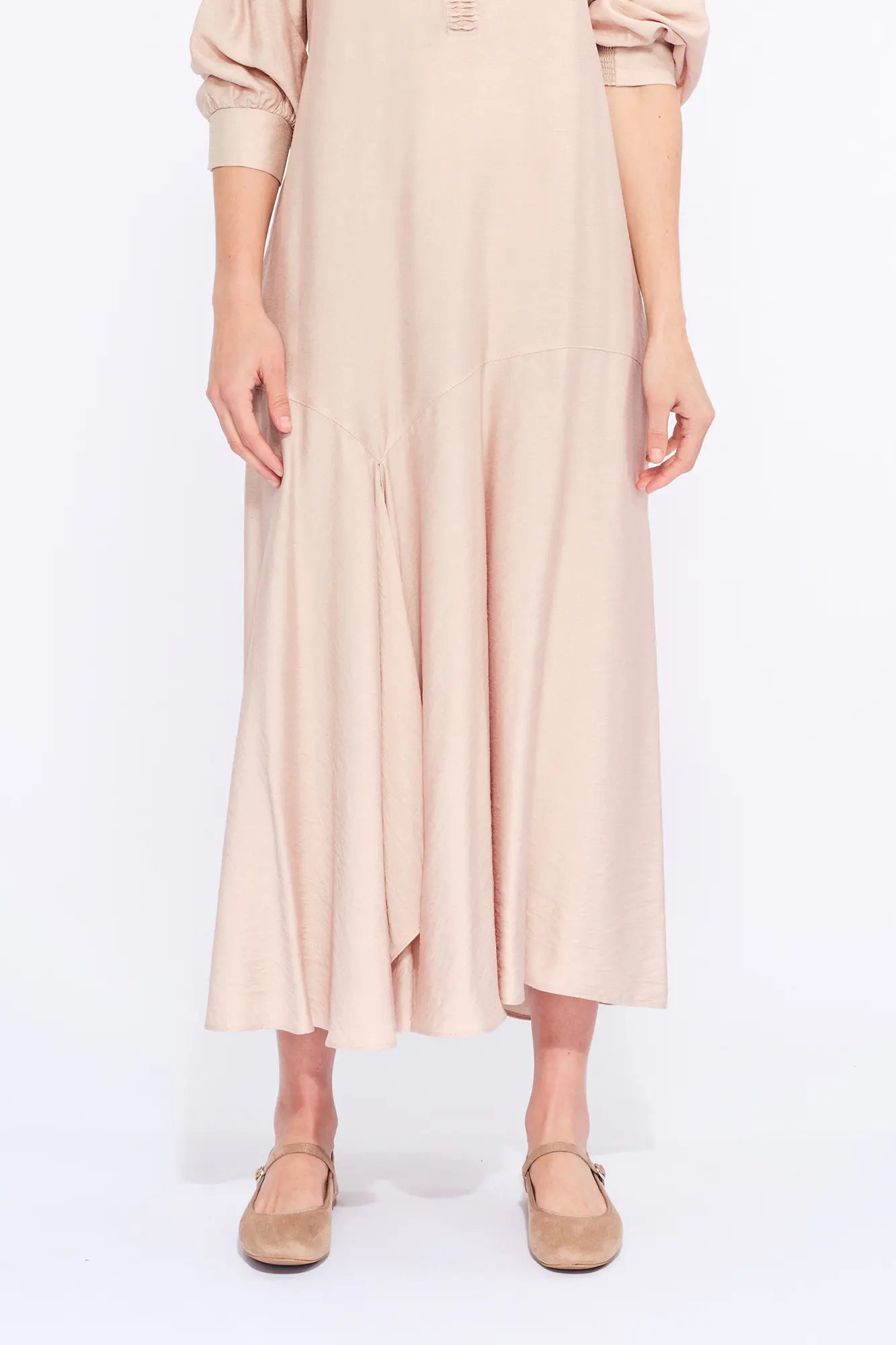 Front view of the Carlie Dress in Nude, showcasing its gathered V-neckline and asymmetrical skirt.