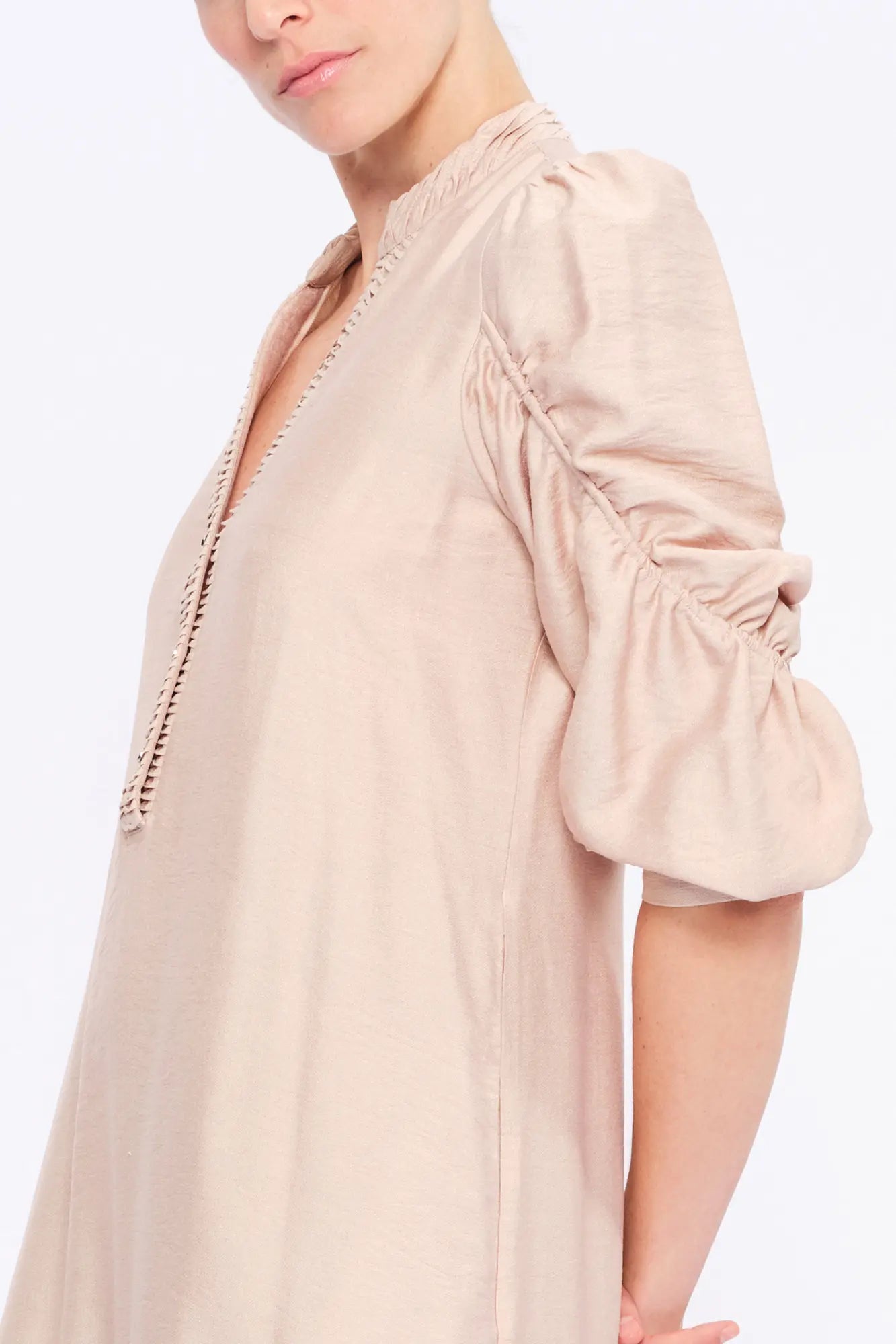 Close-up of the gathered neckline and the proprietary woven fabric of the Nude Carlie Dress.