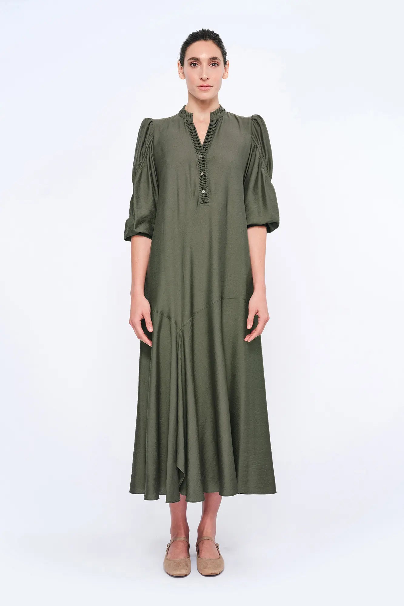 The Carlie Dress in a sophisticated Olive, featuring its soft puff sleeves and draped skirt.