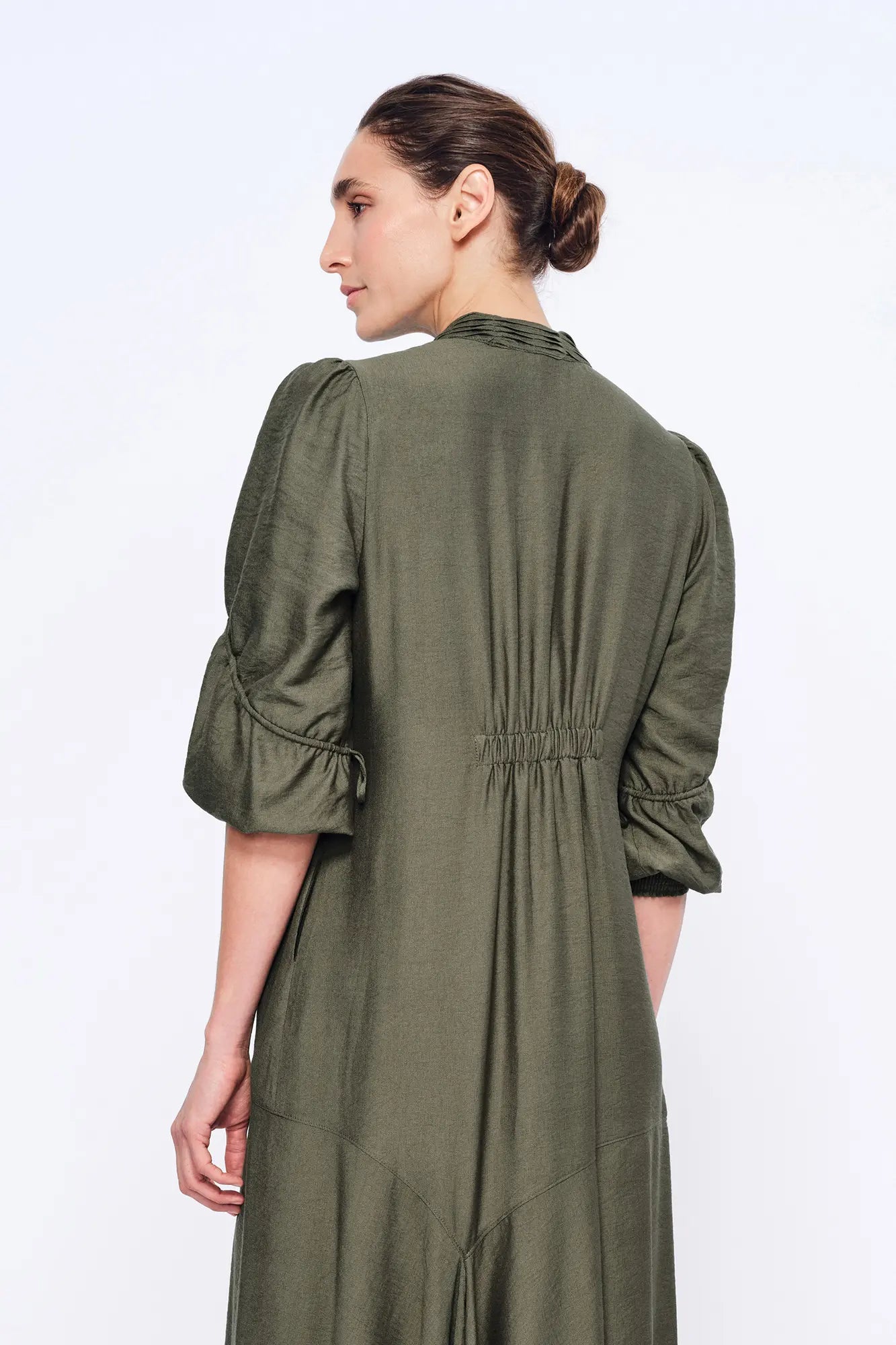 Understated back view of the Carlie Dress in its fluid silhouette.