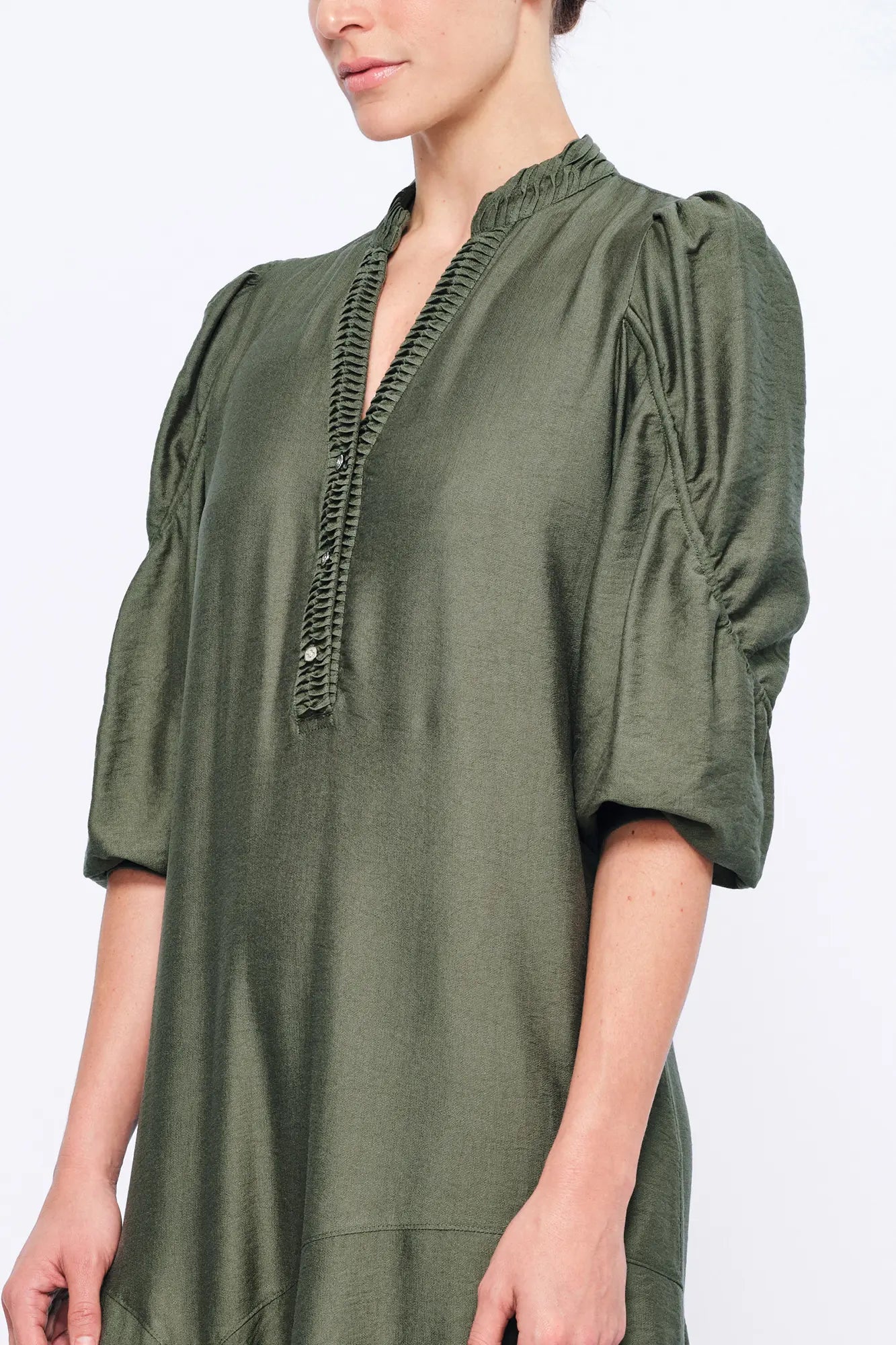 Detail shot of the sculptural puff sleeve construction on the Olive Carlie Dress.