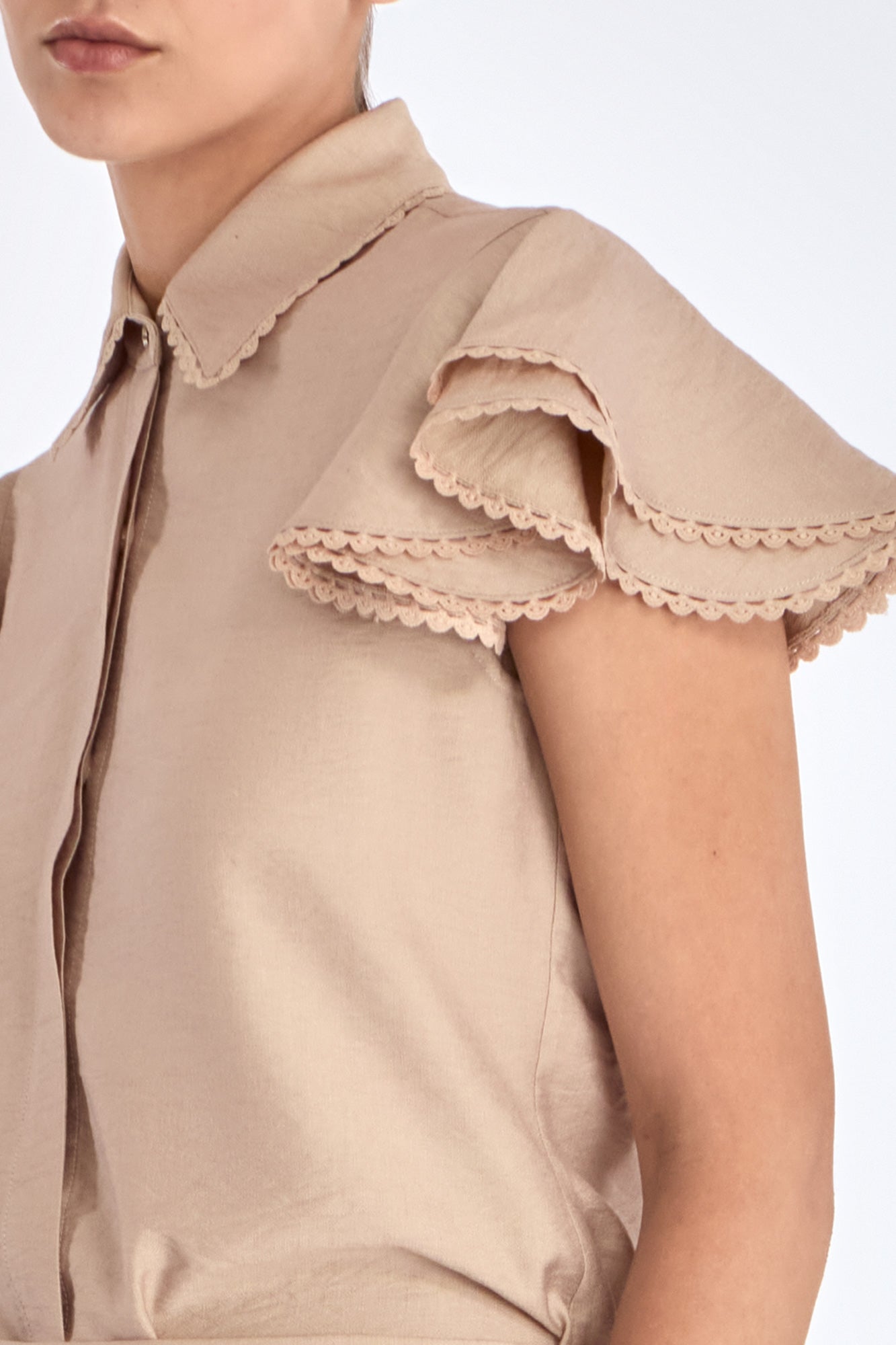 Clark Blouse in Nude – Rayon-blend shirt collar blouse with hidden placket, short ruffled sleeves, and tonal detailing.