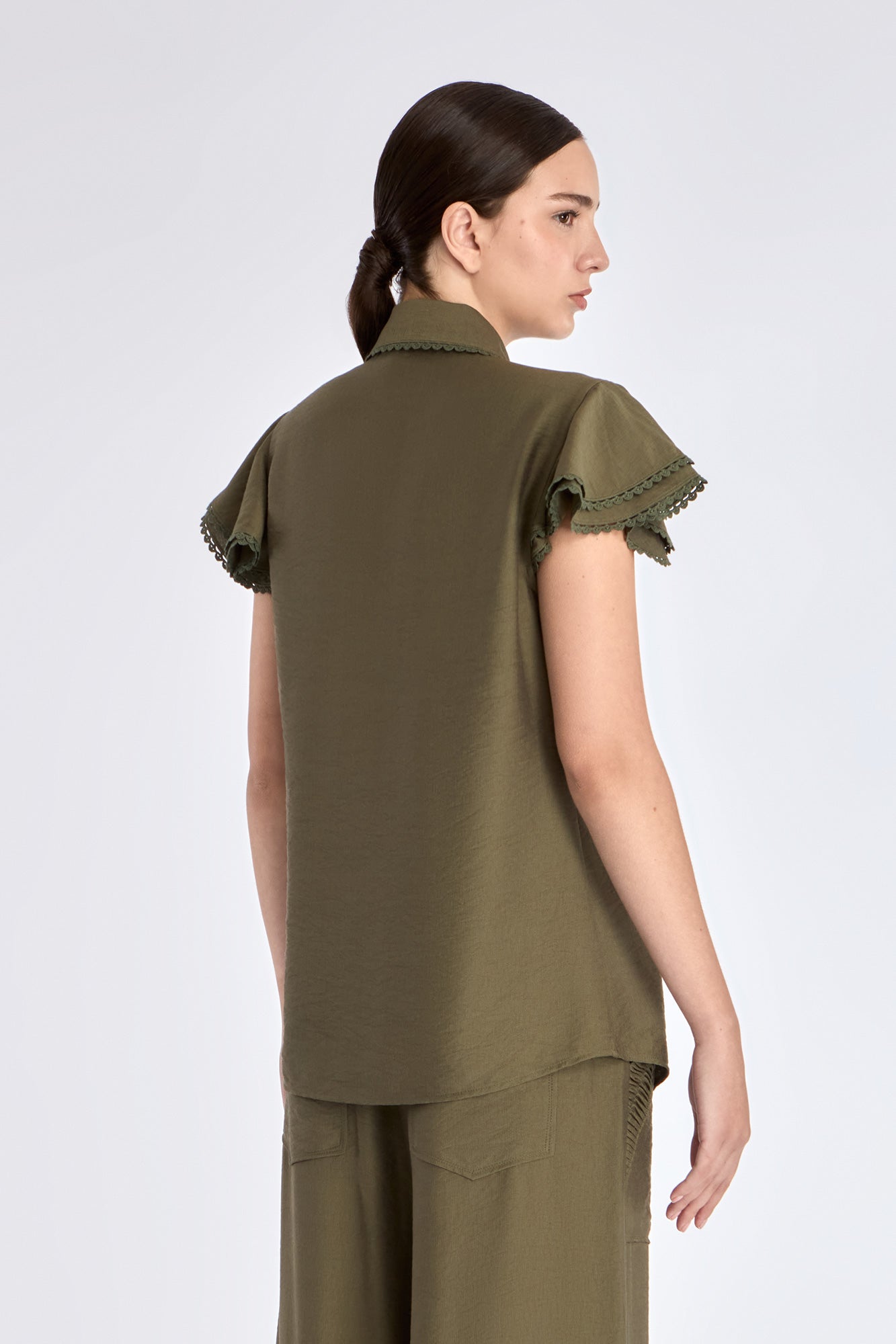 Clark Blouse in Olive – Rayon-blend shirt collar blouse with hidden buttons, ruffled short sleeves, and tonal trim.