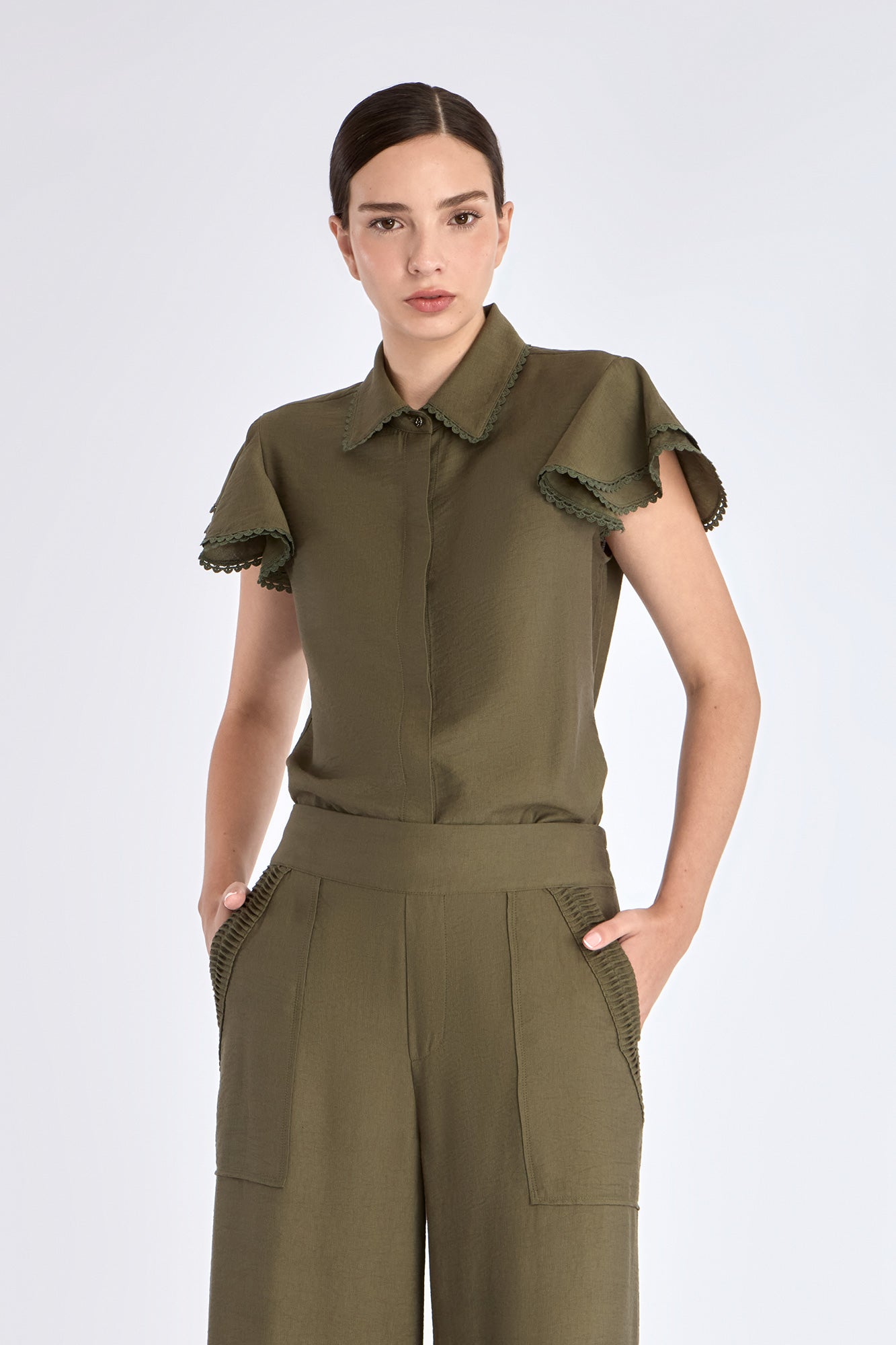 Clark Blouse in Olive – Rayon-blend shirt collar blouse with hidden buttons, ruffled short sleeves, and tonal trim.
