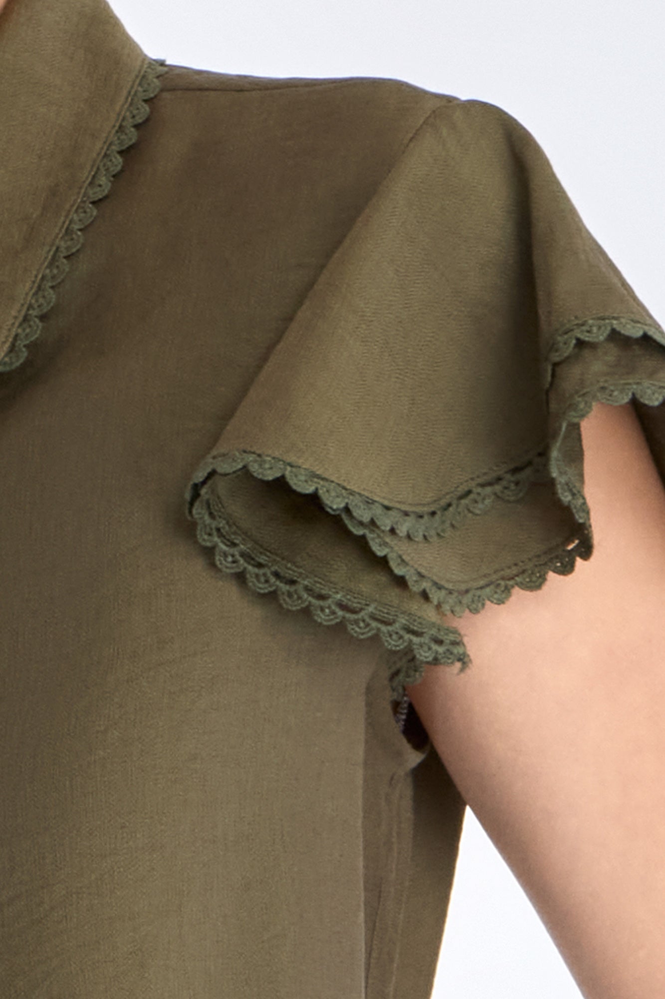Clark Blouse in Olive – Rayon-blend shirt collar blouse with hidden buttons, ruffled short sleeves, and tonal trim.