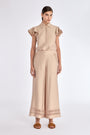 Clark Pant in Nude – Lightweight pants with diagonal patch pockets, elastic waistband, and subtle trim detail at the hem.