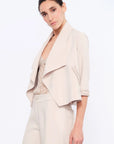 Side view of the Ecru Daysi Jacket, showcasing the graceful drape of its open-front design.