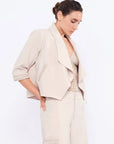 Side view of the Ecru Daysi Jacket, showcasing the graceful drape of its open-front design.