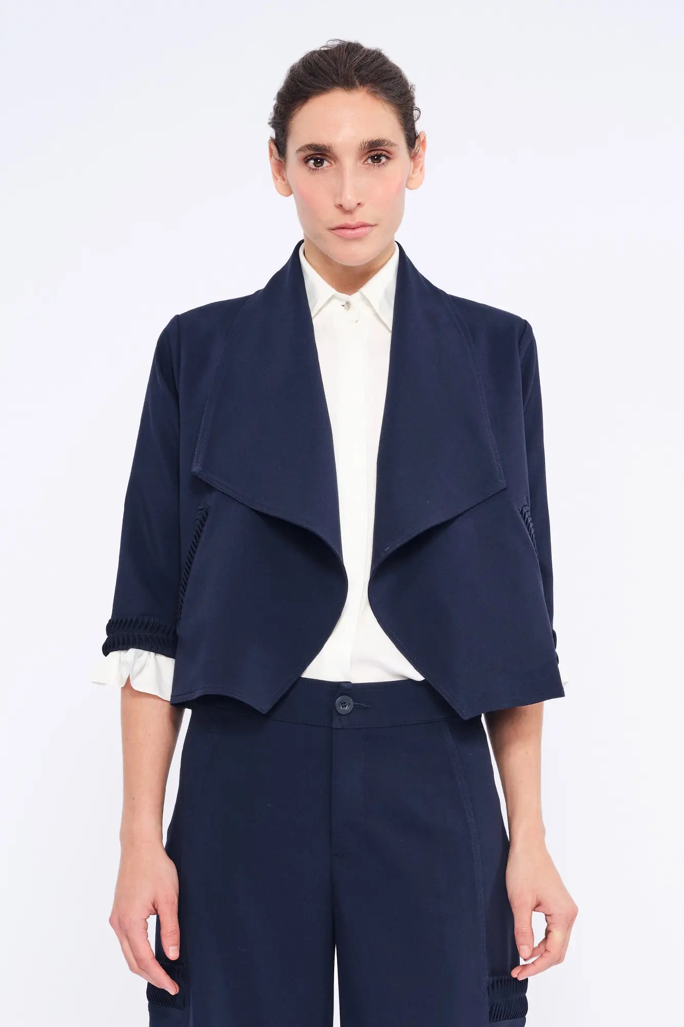 Front view of the Daysi Jacket in Navy, showcasing its elegant draped lapel and open-front design.