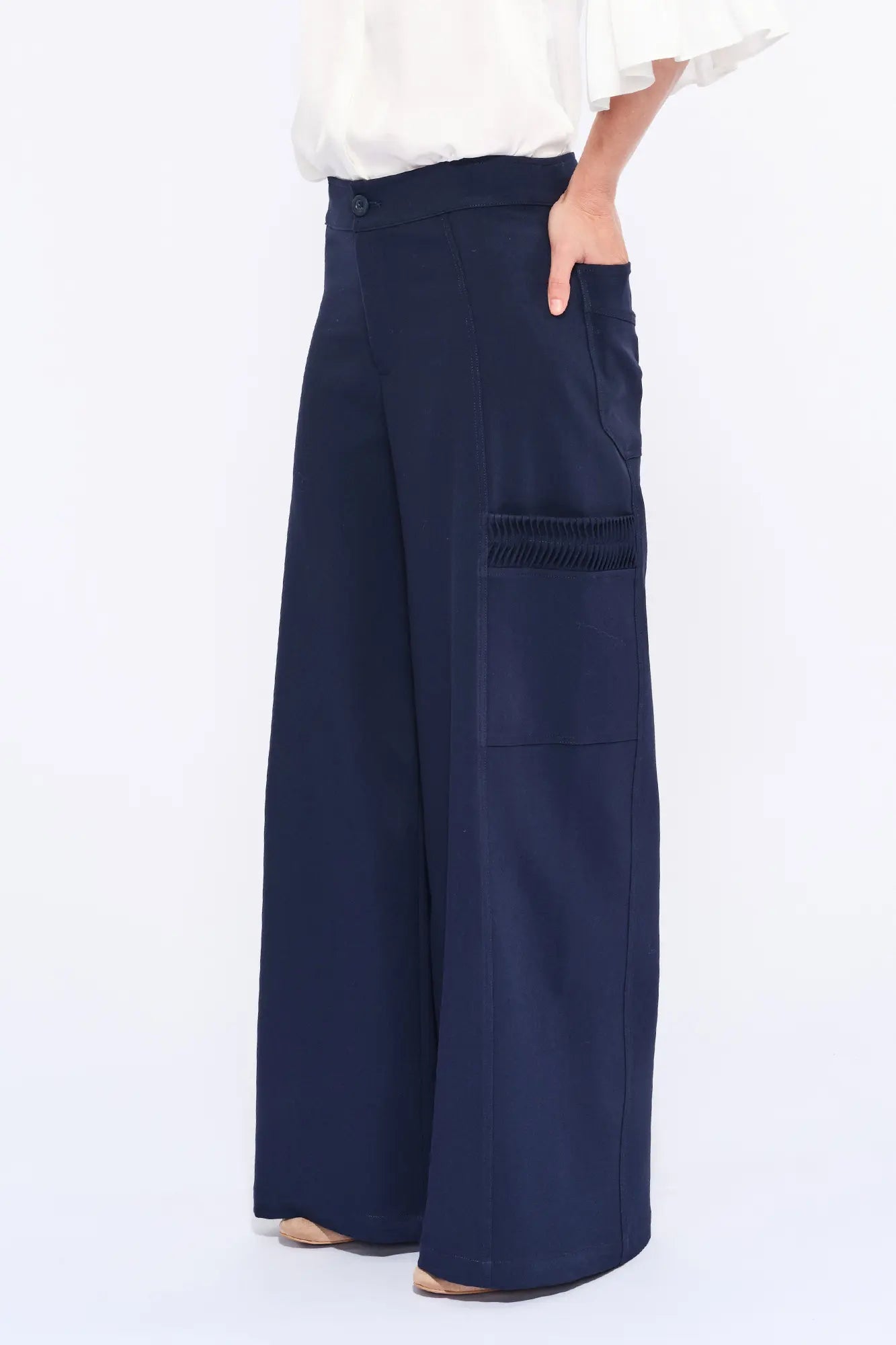 Side profile of the Ecru Daysi Trouser, highlighting the unique raised ruching on the side pocket.