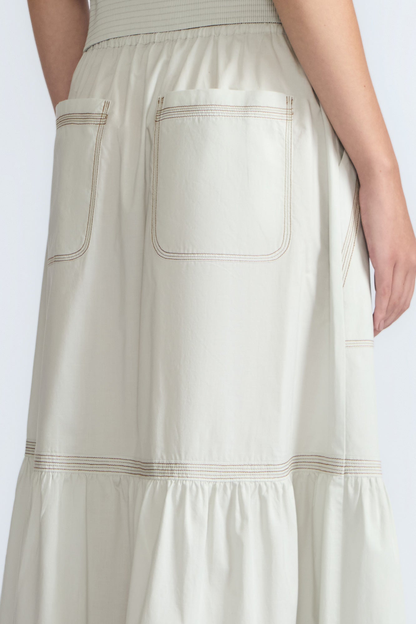 Eden Skirt in Silver – Cotton midi skirt with ruffled hem, patch pockets, and elasticized waistband at the back.