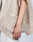 Elaine Poncho in Beige Melange with front patch pockets and dropped sleeves