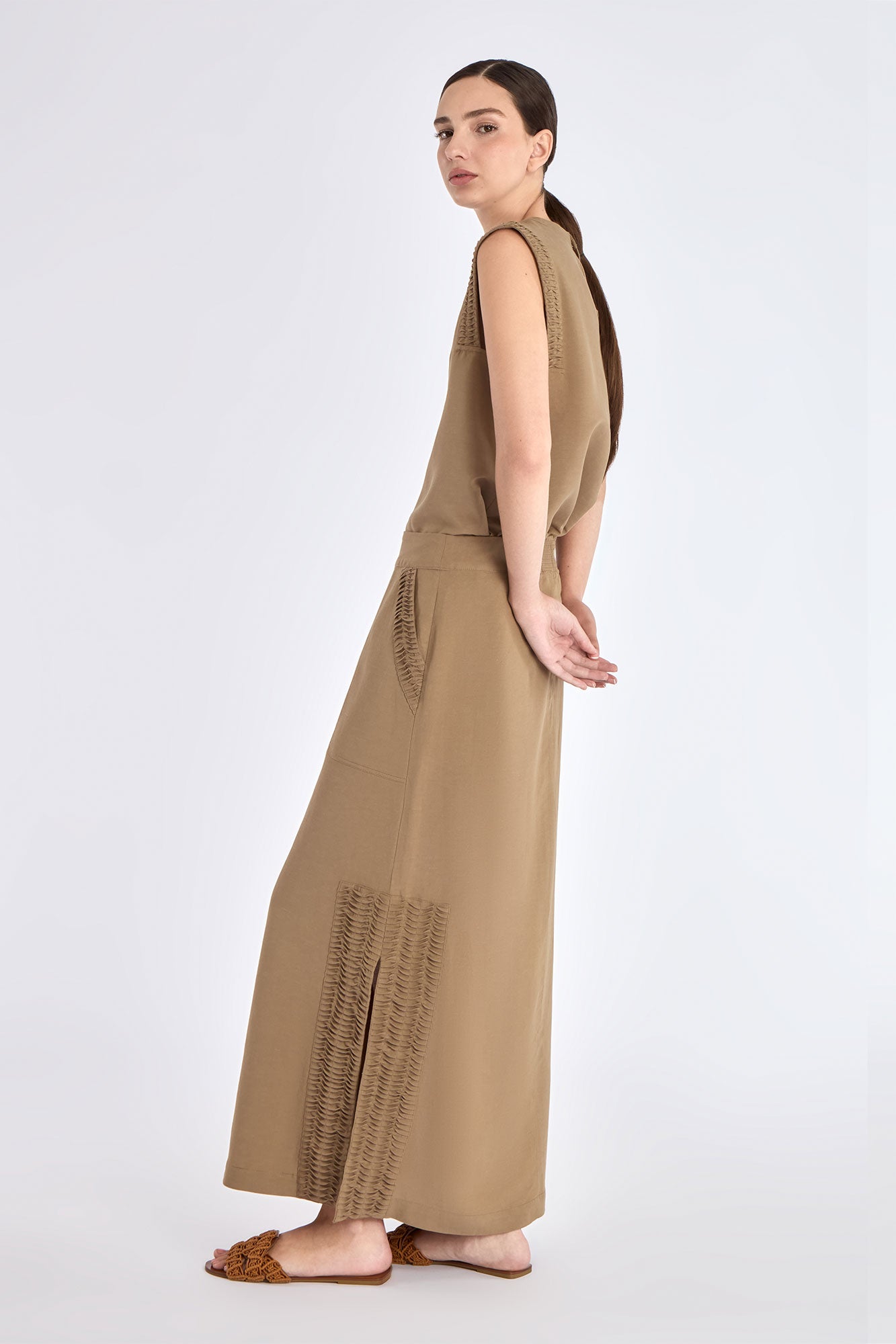 Side profile of the Taupe Indigo Skirt, highlighting the clean silhouette and subtle side slit detail.