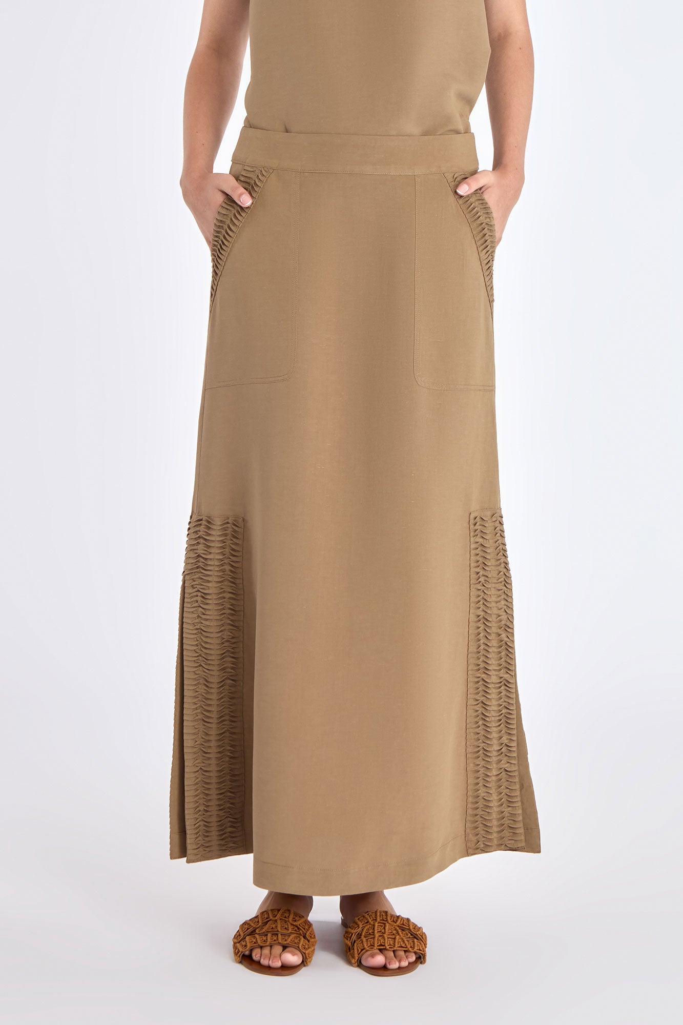 Front view of the straight-cut Indigo Midi Skirt in a sophisticated taupe, showing its diagonal patch pockets.