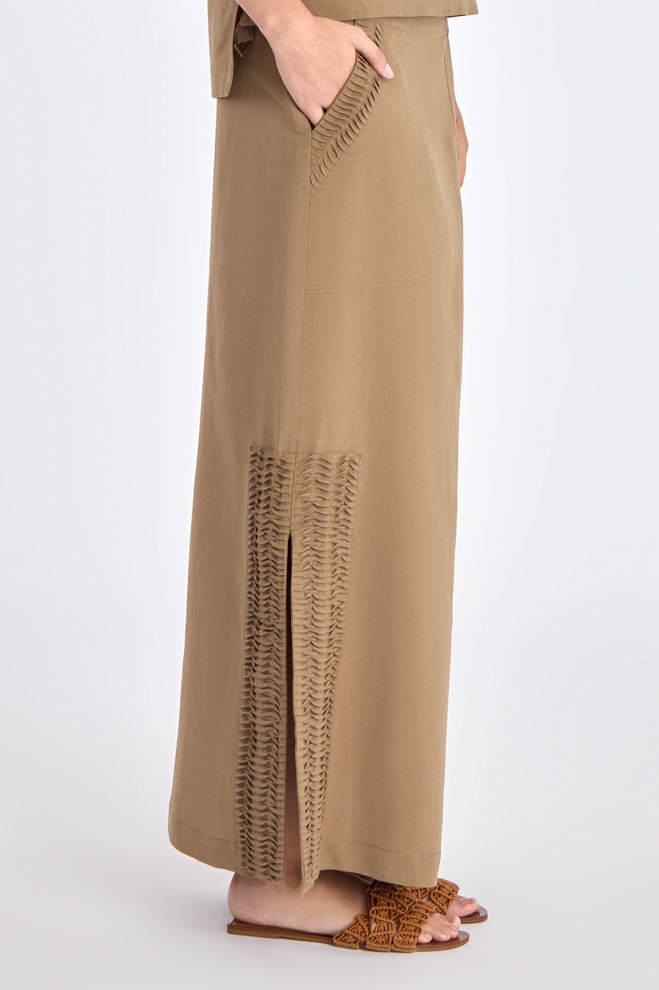 Close-up detail of the premium linen blend fabric and the angled patch pocket on the Taupe Indigo Skirt.