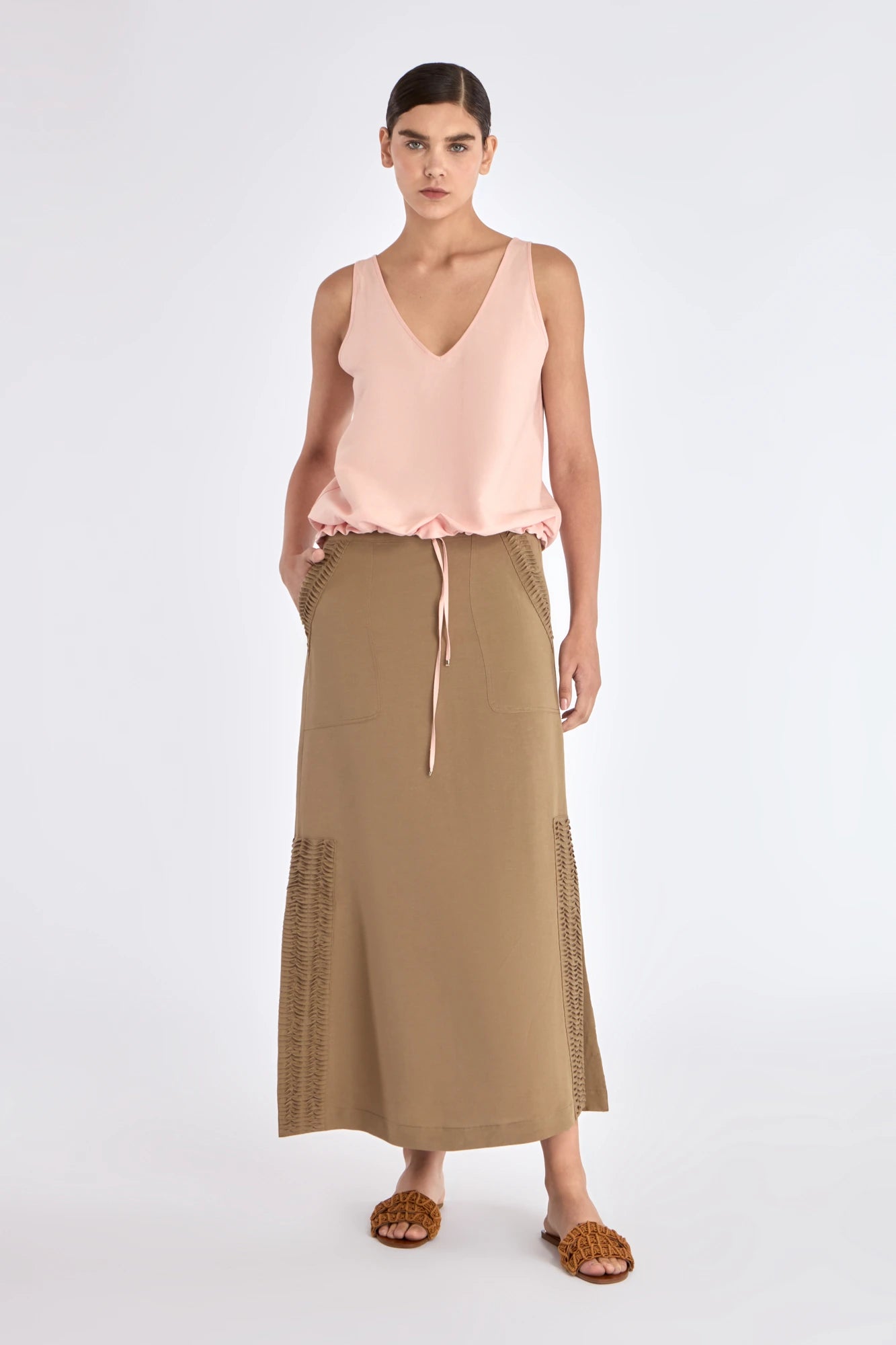 Front view of the straight-cut Indigo Midi Skirt in a sophisticated taupe.