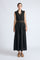 Isidora Dress in Black – Sleeveless midi cotton dress with shirt collar V-neckline, tiered silhouette, and hidden side pockets.
