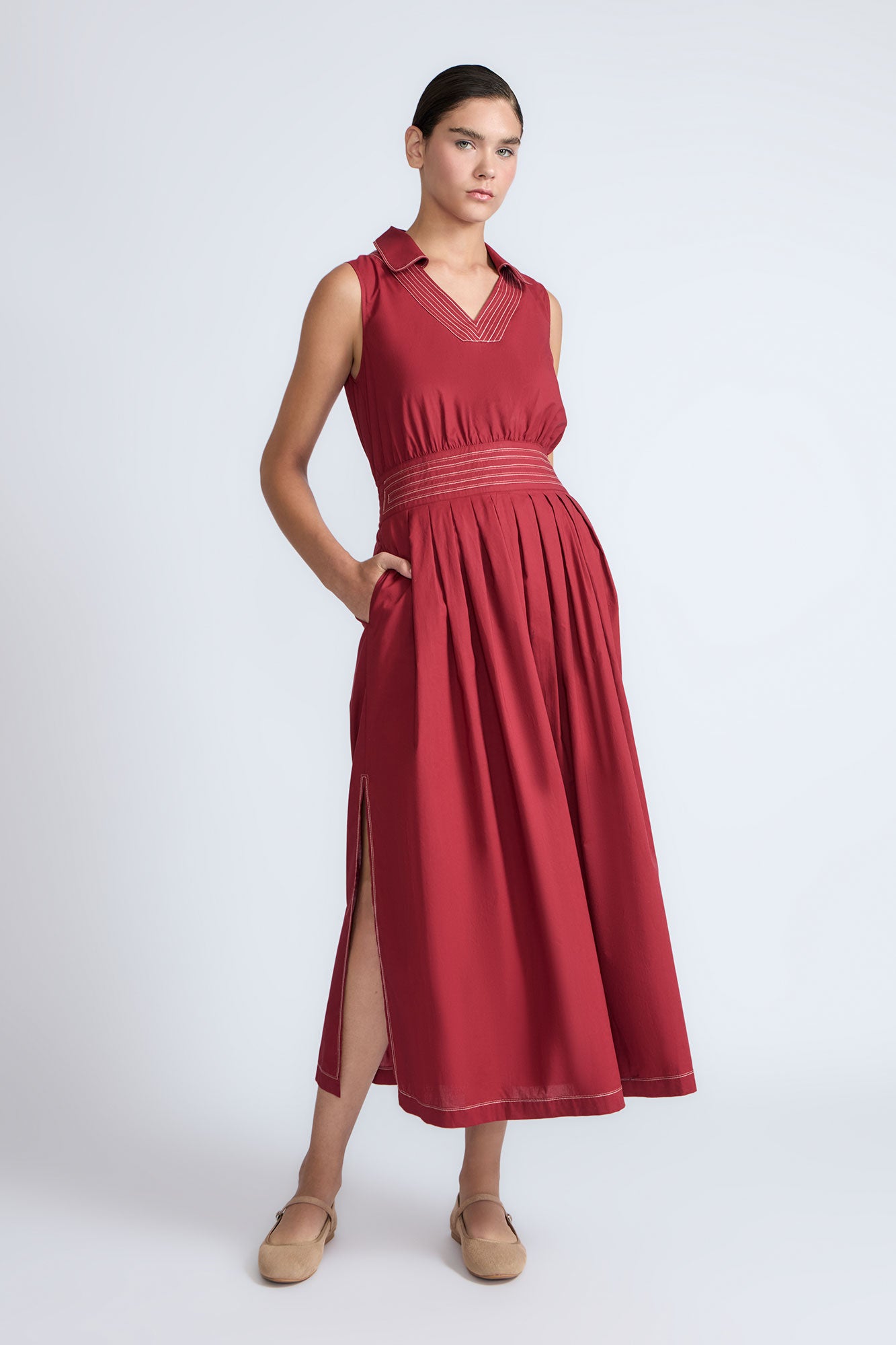 Isidora Dress in Wine – Sleeveless cotton maxi dress with shirt collar, V-neckline, hidden pockets, and tiered silhouette.