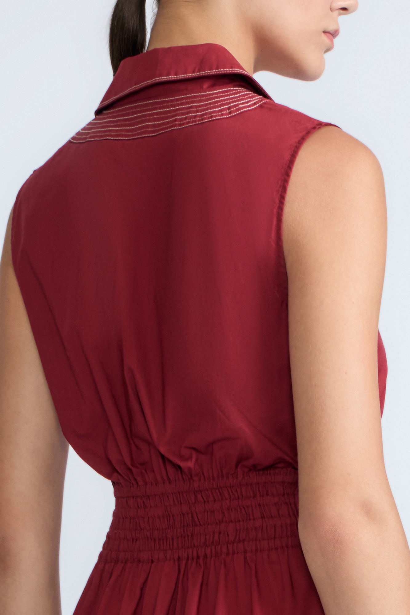 Isidora Dress in Wine – Sleeveless cotton maxi dress with shirt collar, V-neckline, hidden pockets, and tiered silhouette.