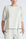 Woman wearing a light-colored blouse with puffed sleeves on a white background
