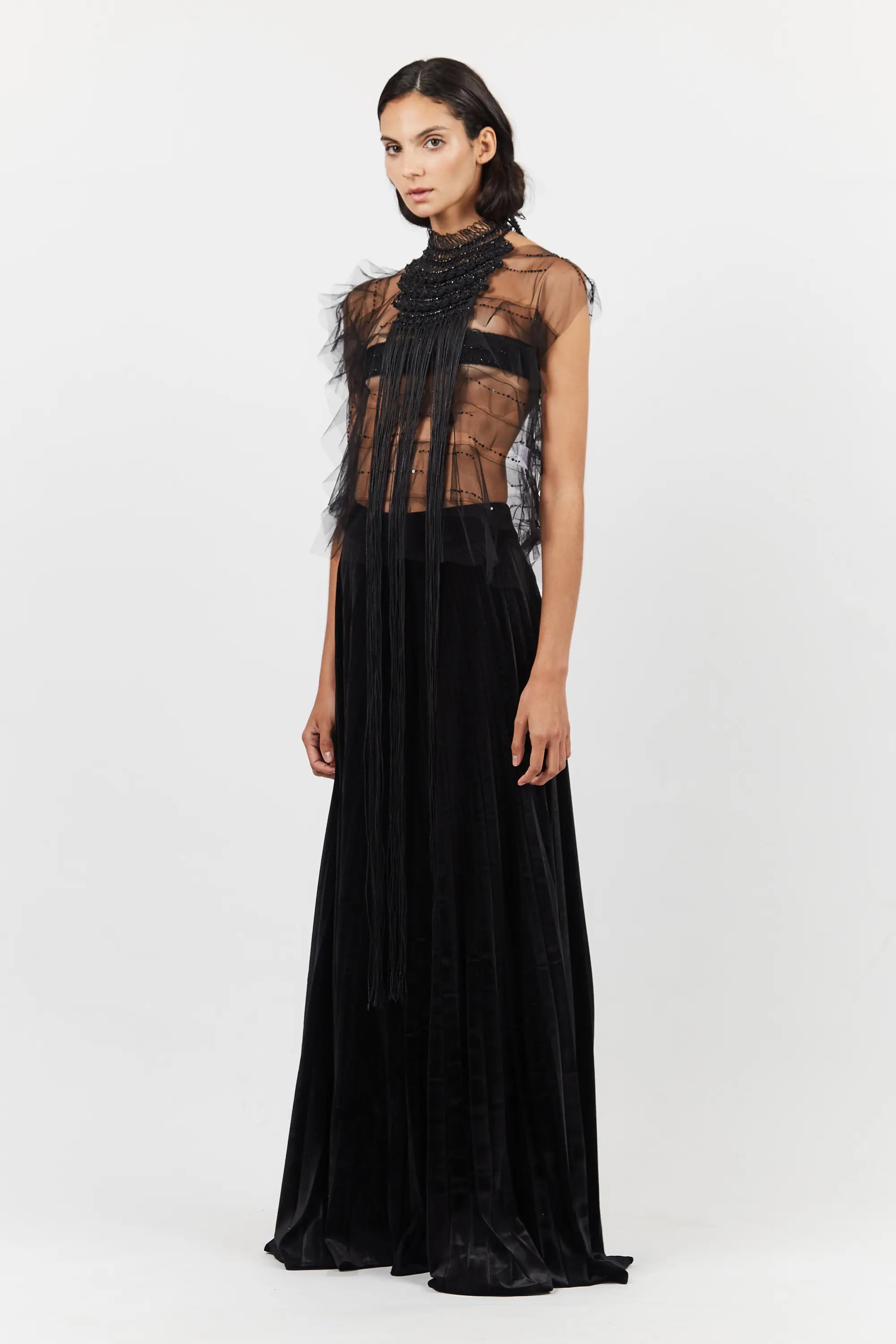 The Lara Peto in Black styled as an overlay on a complementary garment.