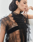 A close-up of the Lara Peto in Black, highlighting the hand-embroidery of beads and crystals on the macrame.