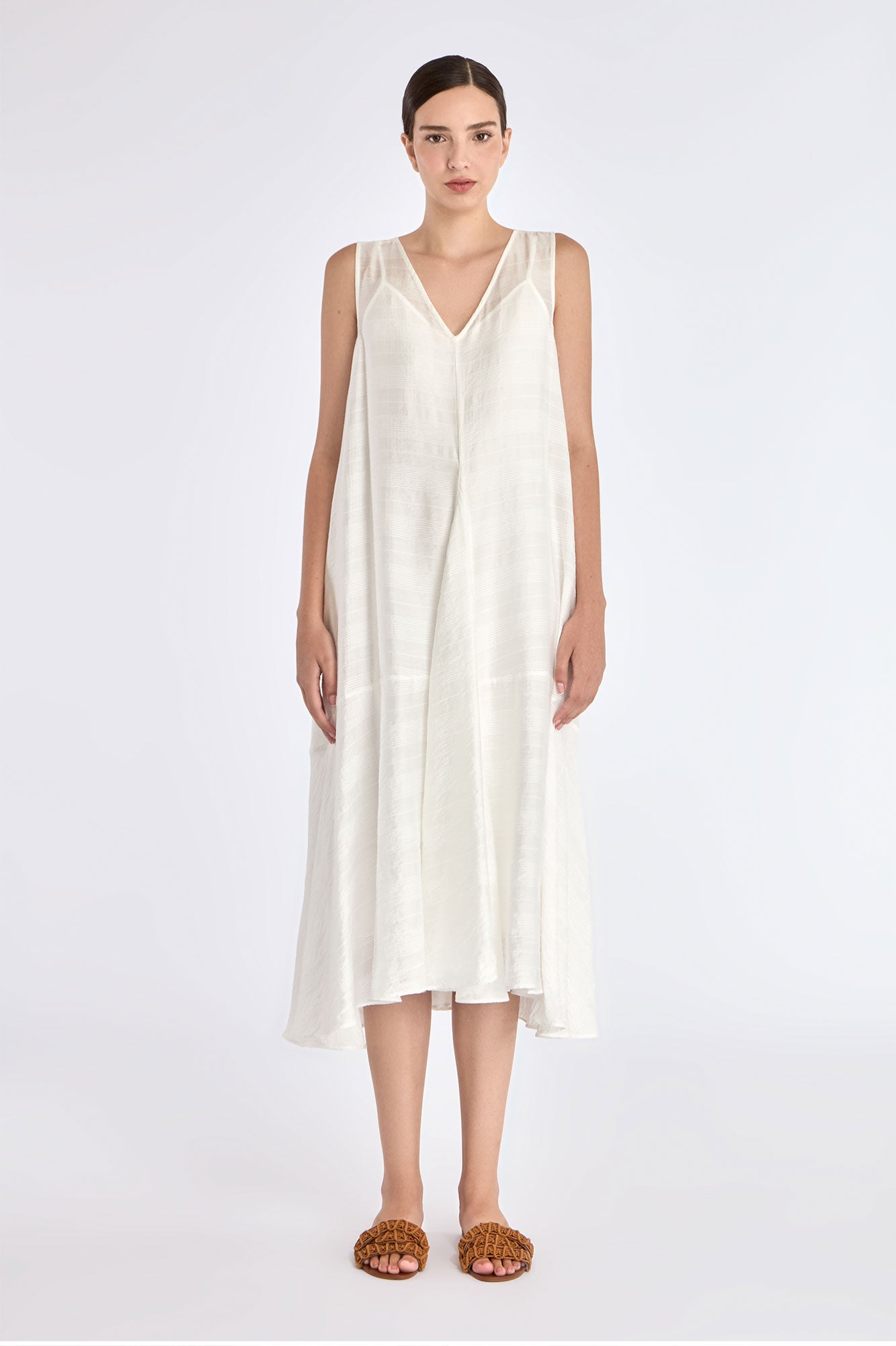 Model wearing the Lenox Godet Dress in Off White.