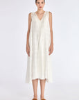 Model wearing the Lenox Godet Dress in Off White.
