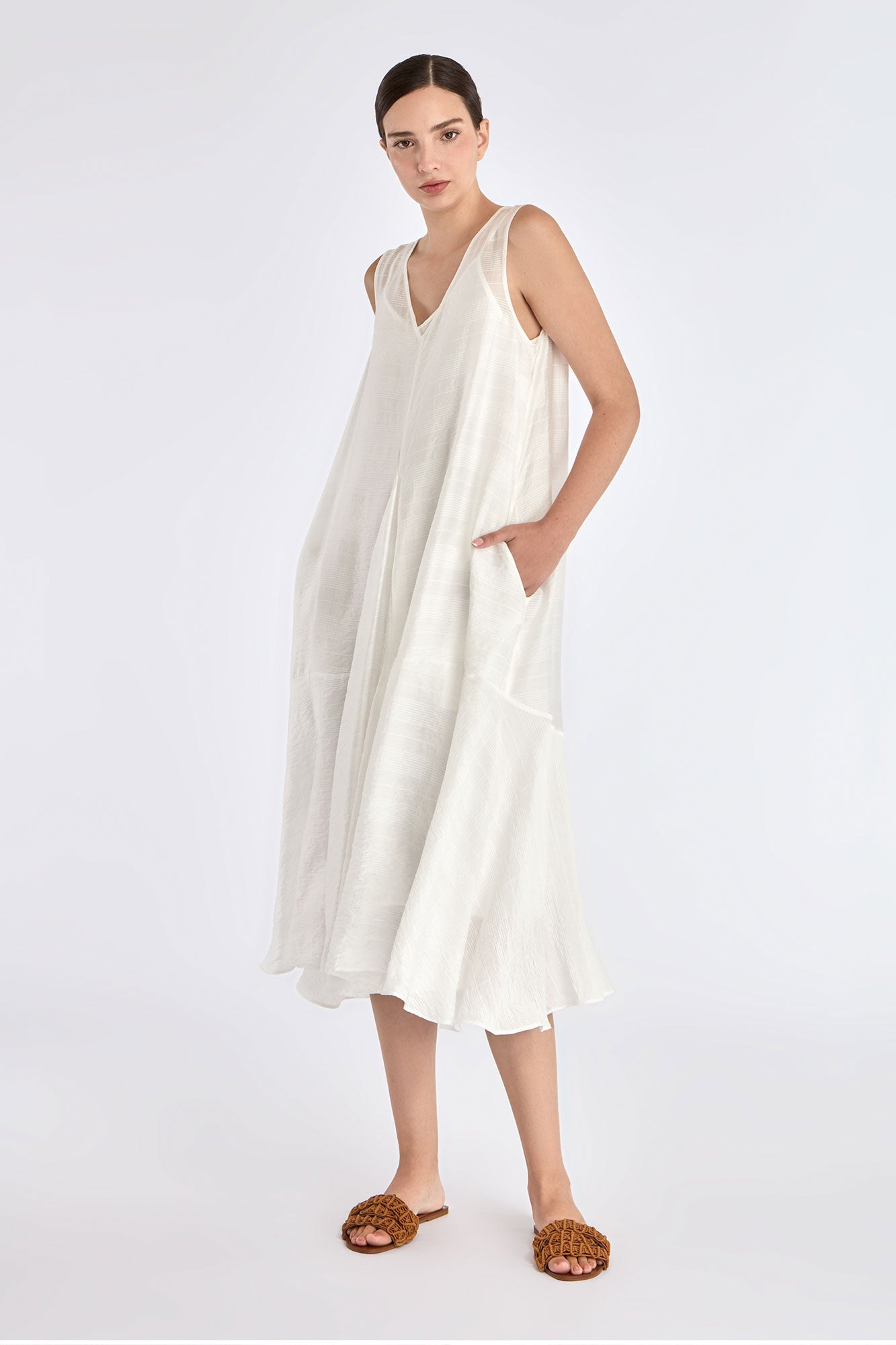 Model wearing the Lenox Godet Dress in Off White.