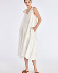 Model wearing the Lenox Godet Dress in Off White.