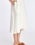 Close-up on the woven texture and godet panel seam of the Off White Lenox Dress.