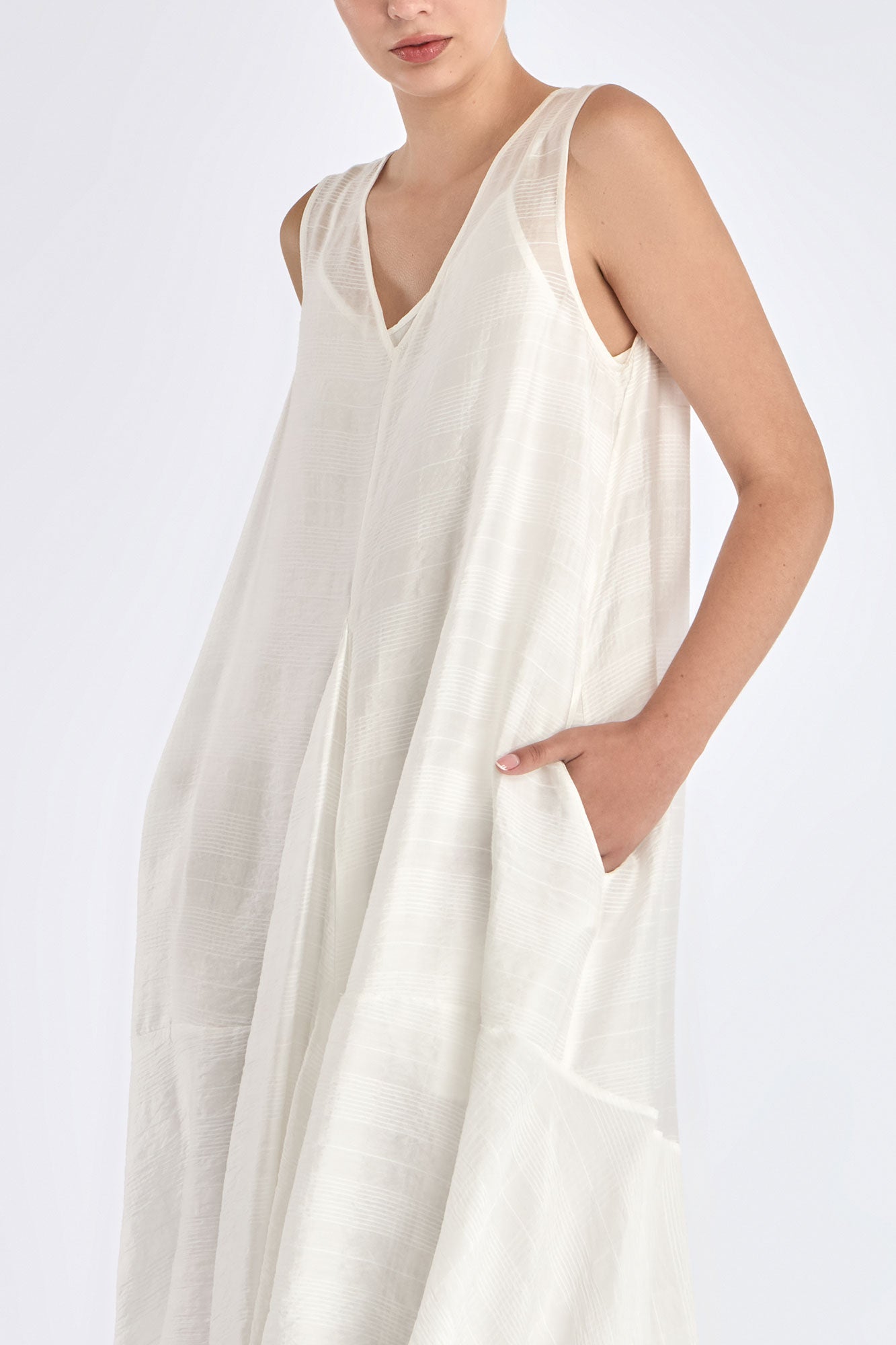 Close-up on the woven texture and godet panel seam of the Off White Lenox Dress.