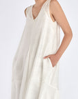 Close-up on the woven texture and godet panel seam of the Off White Lenox Dress.