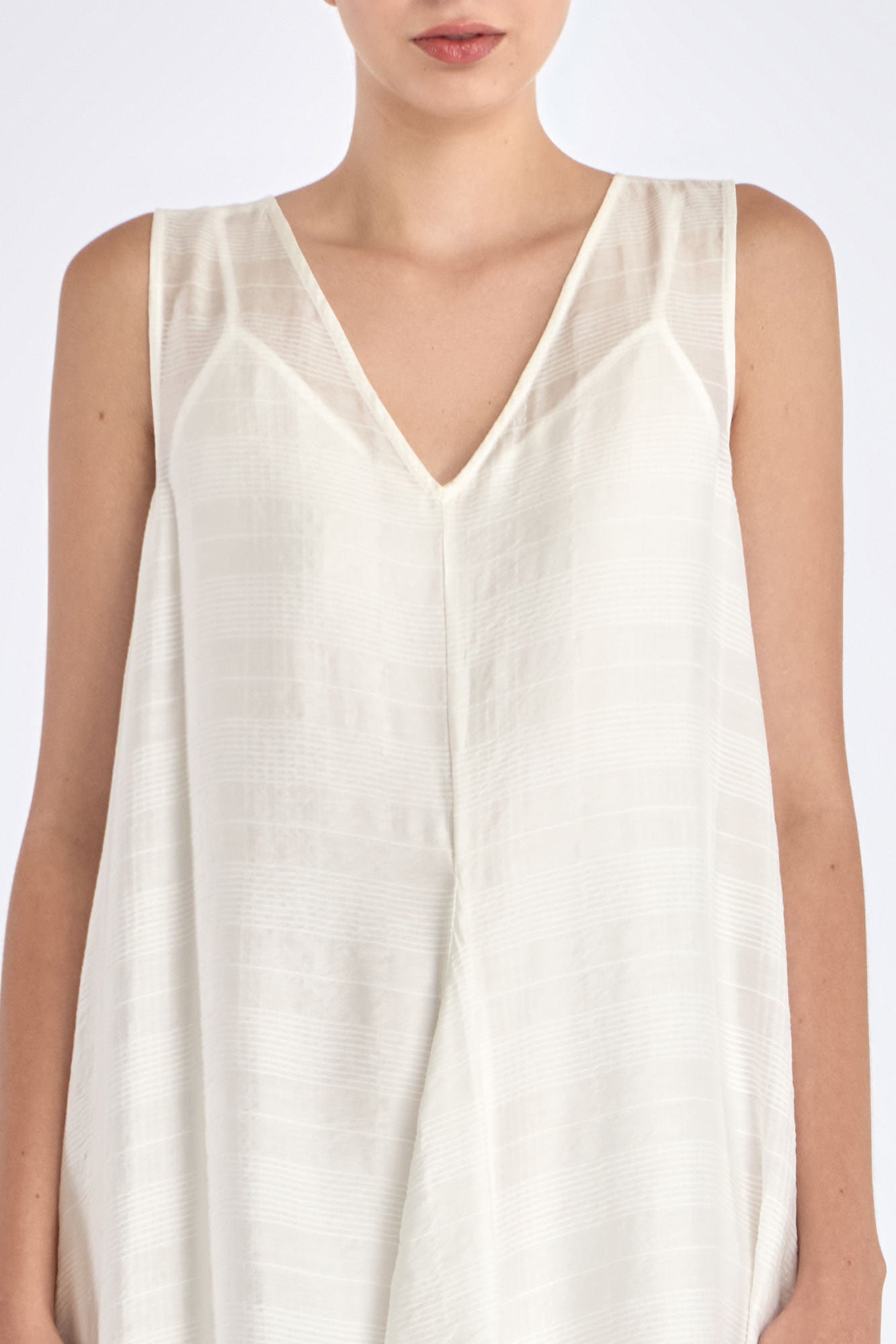 Close-up on the woven texture and godet panel seam of the Off White Lenox Dress.