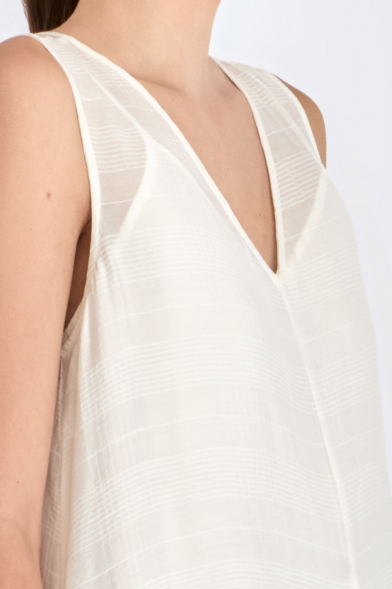 Close-up on the woven texture and godet panel seam of the Off White Lenox Dress.